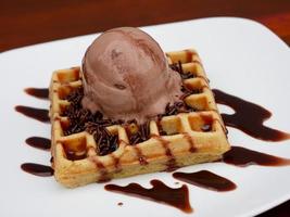 chocolate waffle with ice cream topping and chocolate sprinkles photo