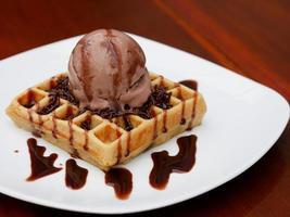 chocolate waffle with ice cream topping and chocolate sprinkles photo