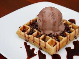 chocolate waffle with ice cream topping and chocolate sprinkles photo