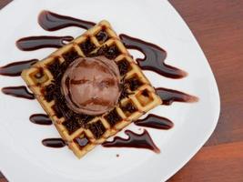 chocolate waffle with ice cream topping and chocolate sprinkles photo