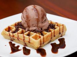 chocolate waffle with ice cream topping and chocolate sprinkles photo