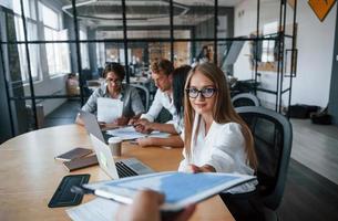 Takes document. Young business people in formal clothes working in the office photo