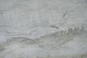 The cement flap surface has scratches, black and white stains, traces caused by plastering to create an artistic pattern photo