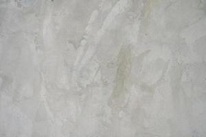 The cement flap surface has scratches, black and white stains, traces caused by plastering to create an artistic pattern photo