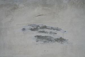 The cement flap surface has scratches, black and white stains, traces caused by plastering to create an artistic pattern photo