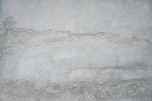 The cement flap surface has scratches, black and white stains, traces caused by plastering to create an artistic pattern photo