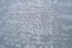 The cement flap surface has scratches, black and white stains, traces caused by plastering to create an artistic pattern photo