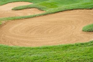 sandpit bunker golf course backgrounds, The sandpit on the golf course fairway is used as a hurdle for athletes to compete photo