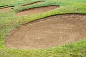 sandpit bunker golf course backgrounds, The sandpit on the golf course fairway is used as a hurdle for athletes to compete photo