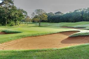 sandpit bunker golf course backgrounds, The sandpit on the golf course fairway is used as a hurdle for athletes to compete photo