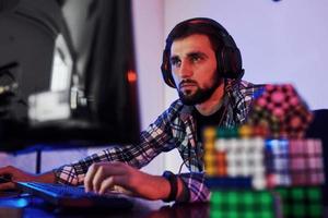 Portrait of young bearded pro gamer playing in online video game photo