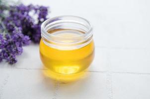 Jar with honey and fresh lavender flowers photo