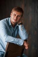 Portrait of man in official shirt that posing for the camera indoors photo