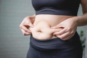 Worried fat woman wearing tight clothes, overweight woman photo