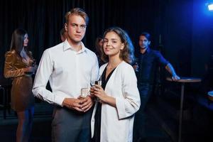 retrato de una pareja encantadora que tiene una fiesta junto con sus amigos foto