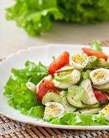 Salad of tomatoes, cucumbers and quail eggs photo