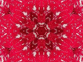 fondo de caleidoscopio floral rojo abstracto patrón único y simétrico para vibraciones navideñas foto