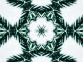 Blurry green leaves kaleidoscope background abstract flower and symmetric pattern for christmas vibes photo