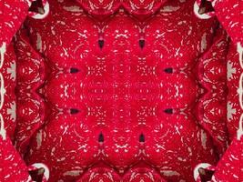 fondo de caleidoscopio floral rojo abstracto patrón único y simétrico para vibraciones navideñas foto