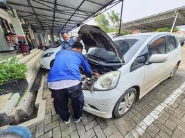 Central Java, Indonesia in October 2022. An officer is carrying out a physical check of a vehicle that will extend or replace its license plate number. photo