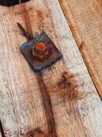 This is a bolt with a rusty nut photo