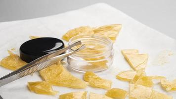 box of golden extract medical marijuana wax and tweezers in hand photo