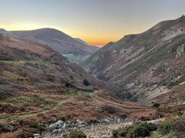 The sun sets in a brilliant red over the mountains of North Wales photo