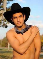 Sexy Cowboy in black cowboy hat. photo