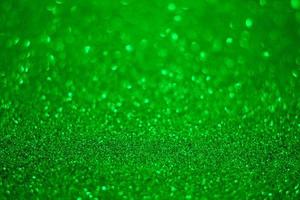 Green glitter background. Texture of the green glitter particles. photo