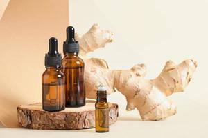 amber glass dropper bottles and ginger root on beige background copy space natural cosmetic concept