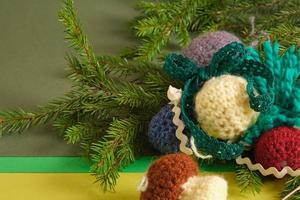 handmade. knitted balls for the Christmas tree, various crocheted Christmas toys, fir branches. photo