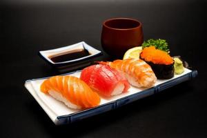 Sushi salmon tuna sushi shrimp and wasabi on the white plate. photo