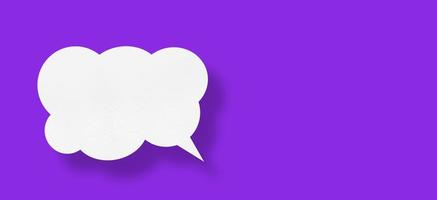 white cloud paper speech bubble shape against purple background photo