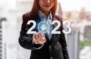 Businesswoman showing 2023 business target, New year resolution with goal, plan and action photo