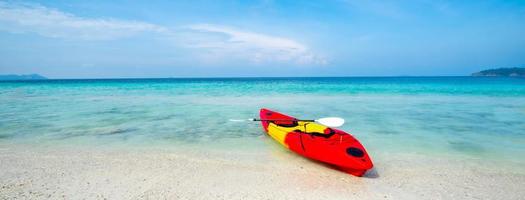 Kayak on the tropical white sand beach with transparent sea on sunny day, Panorama banner photo