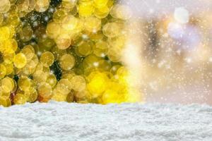 Empty white snow with blur Christmas tree with bokeh light background photo