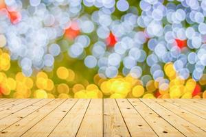 Empty wood table top with blur Christmas tree with bokeh light background photo