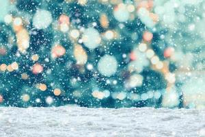 Empty white snow with blur Christmas tree with bokeh light background photo