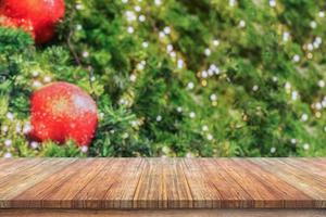 Empty wood table top with blur Christmas tree with bokeh light background photo