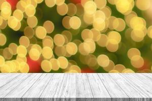 Empty wood table top with blur Christmas tree with bokeh light background photo