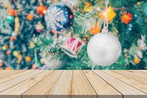 Empty wood table top with blur Christmas tree with bokeh light background photo