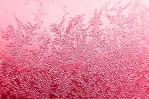 snow pattern on the glass from frost. viva magenta color of the year photo