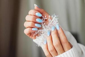Cozy nails with winter manicure with snowflakes photo