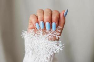 Cozy nails with winter manicure with snowflakes photo