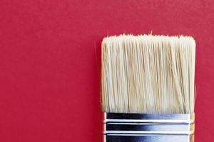Paint brush isolated on a viva magenta background close with copy space photo