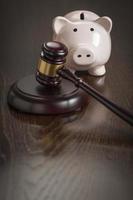 Gavel and Piggy Bank on Table photo