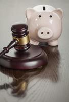 Gavel and Piggy Bank on Table photo