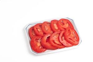 sliced tomatoes in a plate on a white background photo