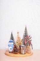 Christmas and New year still life composition fat home interior. Xmas decorations with snowman, deer, Christmas trees photo