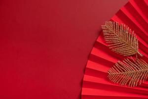 Paper fan and golden twigs symbol Chinese new year top view with copy space photo